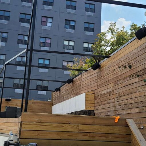 The elevated area and the in-house wall-mounted speakers at The Outer Space (Bronx, NY) outdoor event venue are available for a private family gathering or party with friends.